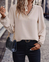 Ruffled V-neck solid color blouse