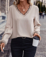 Ruffled V-neck solid color blouse